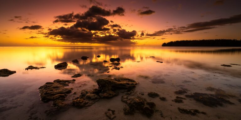 Photo by Fabien BELLANGER the sun is setting over a body of water